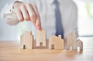 Hand of businessman choosing house model, Planning buy Real Estate