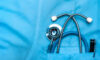 Image of a stethoscope in the pocket of a scrub top.
