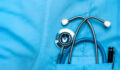 Image of a stethoscope in the pocket of a scrub top.