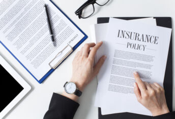 Business woman showing insurance document over white desk at office