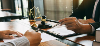 Lawyer is explaining about the wrongdoing laws regarding fraud to the client at the office.