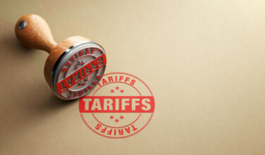 Wooden tariffs stamp, from Getty Images.