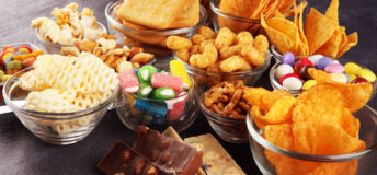 Salty snacks. Pretzels, chips, crackers in glass bowls.