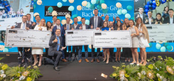 Blackstone's Jonathan Gray with winners and runner-ups of Blackstone Gives Back Challenge.