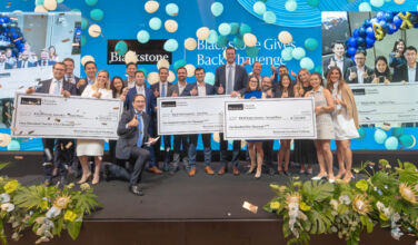 Blackstone's Jonathan Gray with winners and runner-ups of Blackstone Gives Back Challenge.