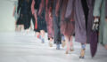 Fashion Show, Catwalk Runway Show Event. Detail of lined up rear view, fashion models.
