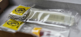 Urine Container: plastic tube in a Biohazard Bag inside a Box. Healthcare concept: blood test. Urine Sample Test Kit.