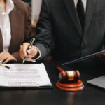 Sun Capital closes single asset CV for Fletchers; Brookfield looks to expand with secondaries push business people and lawyers discussing contract papers sitting at the table. Concepts of law, advice, legal services.