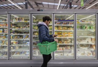 Photograph of a man shopping in a grocery store.