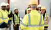 Construction, teamwork and people in meeting for planning, brainstorming and discussion in building. Architecture, engineering and men and women for inspection, property development and project