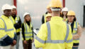 Construction, teamwork and people in meeting for planning, brainstorming and discussion in building. Architecture, engineering and men and women for inspection, property development and project