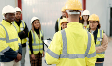 Construction, teamwork and people in meeting for planning, brainstorming and discussion in building. Architecture, engineering and men and women for inspection, property development and project