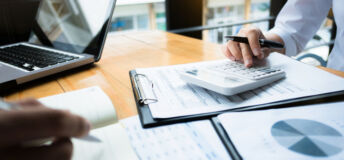 business audits using a calculator financial data investment fund at a workplace, wealth concept
