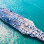 Image of a military navy nuclear aircraft carrier, Military navy ship carrier full loading fighter jet aircraft.