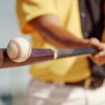 Major League Baseball drawing significant investor interest despite potential lockout Baseball player hitting a baseball with a bat.
